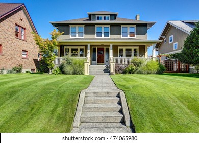 Nice curb appeal of American craftsman style house. Column porch view and well kept lawn in the front. Northwest, USA
