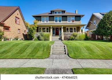 Nice curb appeal of American craftsman style house. Column porch view and well kept lawn in the front. Northwest, USA