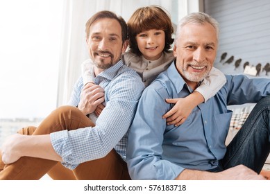 Nice Delighted Boy Hugging His Family