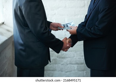 Nice doing business with you. Two corporate businessmen shaking hands and making a financial deal.