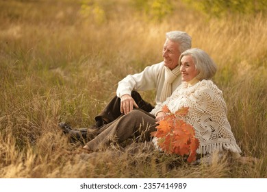 Nice elderly couple in a autumn park. High quality photo. High quality photo - Powered by Shutterstock