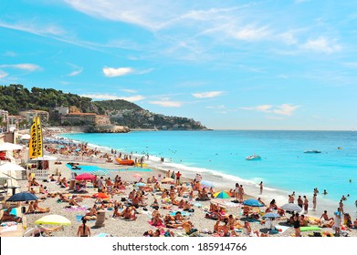 NICE, FRANCE - AUGUST 10, 2011: People Relaxing On The Public Beach In Nice, France, Near The Promenade Des Anglais On Summer Hot Day