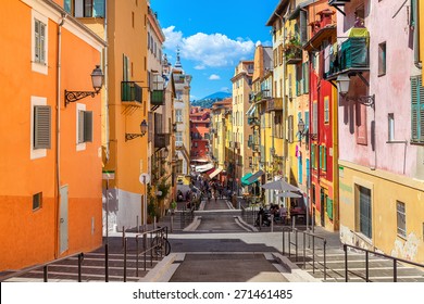 NICE, FRANCE - AUGUST 23, 2014: Narrow street in old part of Nice - fifth populous city and one of the most visited in France, receiving 4 million tourists every year.