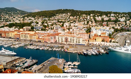 Nice, France - August 30, 2018: Aerial panoramic view over Lympia port (Port of Nice) with luxury yachts, azure waters of Mediterranean sea and mountains on the background.