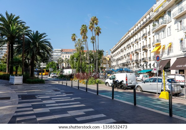 Nice, France - September 18, 2018: Buildings,\
streets, cycle paths, sidewalks, cars, palm trees together with the\
blue sky make up the landscape of this city, which is the\
destination of many\
tourists