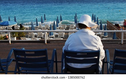 Nice, France-September 26, 2010: Old Lady Relaxing By The Beach. Promenade Des Angles.