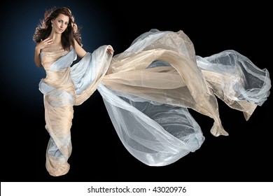 nice girl is wrapped in long silk fabric