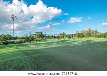 The nice golf  green with the blue cloud