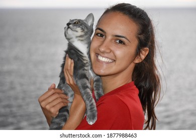 Nice Gray Tabby Cat, The Owner With Her Pet At Sunset