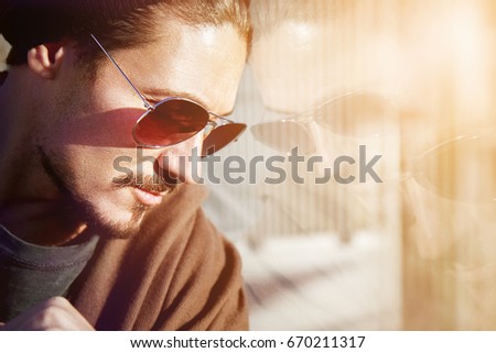 Similar – black haired man posing with sunglasses