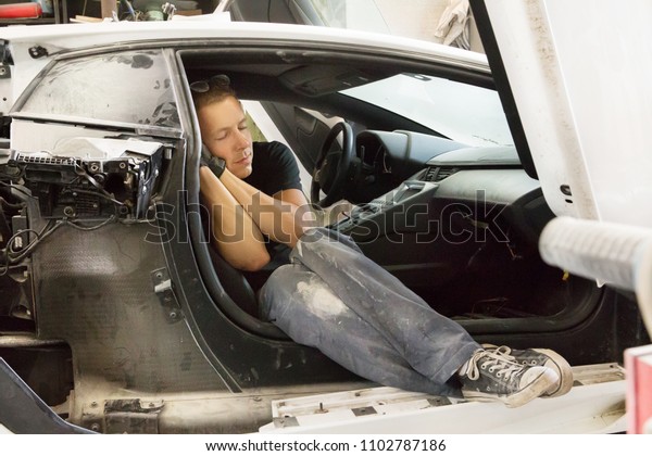 a nice guy\
worked in the garage and fell asleep in a dismantled powerful car\
with glasses and black gloves