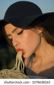 Nice Image Of A Beautiful Woman Eating Pasta In Black Hat