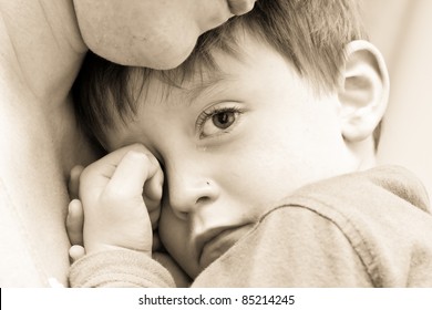 Nice Image Of A Young Upset Boy Cuddling His Mum