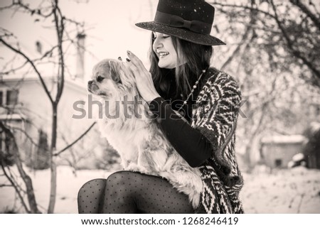 Nice latina woman with little red dog pekingese breed. Pet lover, lady and her best friend on a walk
