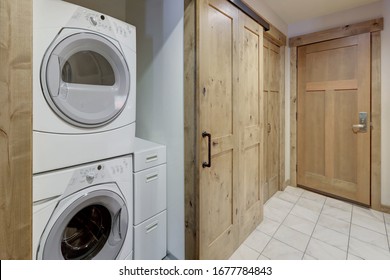 Nice Laundry Room White Washer And Dryer Stack On Each Other In Condo Hallway.