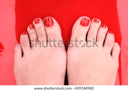 nice legs with pedicure isolated on the red background
