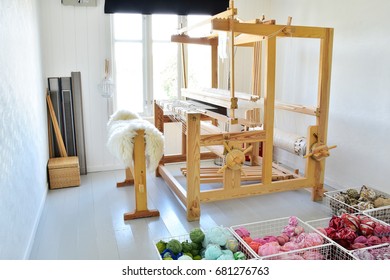 Nice light weaving room. Wooden loom used for making rag carpets in the a room with white walls, a weaving loom in Tromøy, Arendal city, Norway. a traditional hand weaving. old style. beautiful loom.