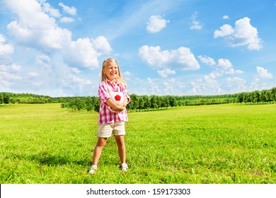 Nice Little 6 Years Old Blond Cute Girl In Pink Shirt With Soccer Ball Standing In The Park On Sunny Summer Day