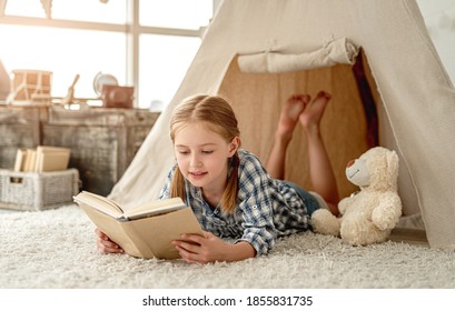 Nice little girl with paper book - Shutterstock ID 1855831735