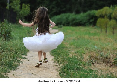 Nice Little Girl  With Very Long Dark Hair In White Tutu Skirt Jump And Run Away