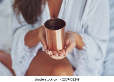 Nice Looking Brunette Woman With Copper Cup Of Water