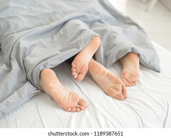 Nice loving couple lying in bed under blanket. - Shutterstock ID 1189387651