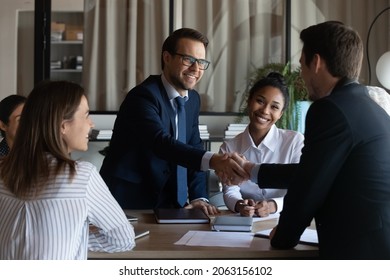 Nice to meet you in our team. Friendly man leader boss shake hand of new staff member welcome young male on job in corporate department. Professional businesspeople reached agreement on negotiations - Shutterstock ID 2063156102