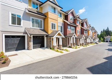 Nice neighborhood on a sunny day. Townhouses in the suburbs of the North America. Canada.