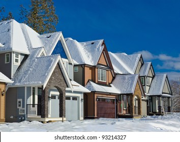 Nice Neighborhood In Winter Time With Dark Blue Sky And Snow..