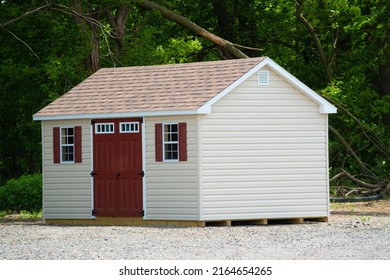 a nice new gray storage shed nature door tool spring trees outside