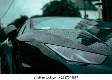 A nice new sportcar with raindrops on it