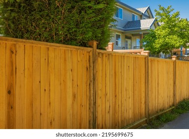 Nice New Wooden Fence Around House. Wooden Fence With Lawn. Street Photo, Selective Focus