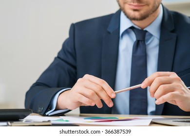 Nice office worker holding pen - Shutterstock ID 366387539