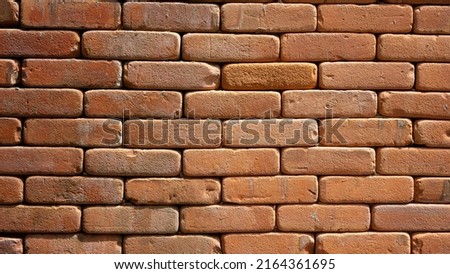 Nice old brick wall for background. Macro shot.Seamless masonry clay block vintage style.Background construction backdrop brickwork rustic materials orange color.Retro grunge tilable surface Aged.