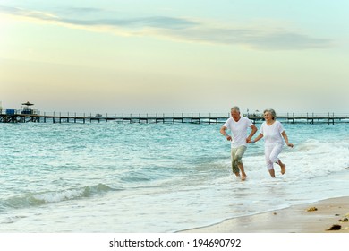 Nice Old Couple Running On Sea Beach