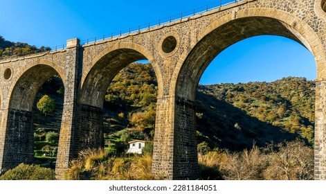 nice old vintage bridge with big arcs and columns among nature with green garneds and blue sky , european old concept landscape - Shutterstock ID 2281184051