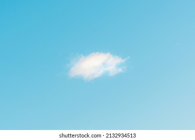 Nice one white fluffy cloud in the blue sky.Blue sky background with cloud.