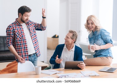 Nice Pleasant Man Telling A Story To His Colleagues