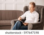 Nice pleasant man using a tablet