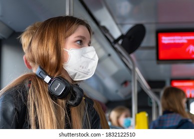 Nice Pretty Worried Young Girl Wearing Mask And Earphones Or Headphones In A Bus, Train Or Metro Going To School During Covid Or Coronavirus Outbreak, Masks Mandatory, Compulsory