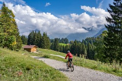 Nice Senior Woman Riding Her Electric Mountain Bike In The Allgau Alps Near Oberstdorf, Bavaria, Germany