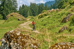 Nice Senior Woman Riding Her Electric Mountain Bike In The Bregenz Forest Mountains Near Hittisau, Vorarlberg Austria
