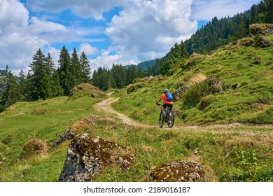 nice senior woman riding her electric mountain bike in the Bregenz Forest mountains near Hittisau, Vorarlberg Austria

