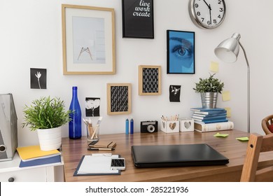 Nice stylish pictures on wall above desk in office