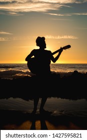 
Nice Sunset Landscape On A Beach With A Guy Playing The Guitar