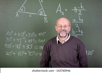 Nice Teacher Smiling At Camera In His Classroom