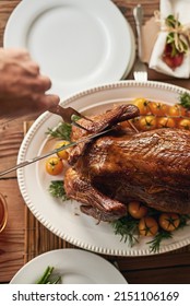 Nice And Tender. Shot Of A Unrecognizable Person Cutting Up A Roast Chicken For The Other People To Eat.