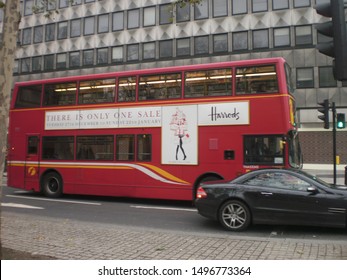 Nice Typical Red Bus With Harrods Ad In London. December 26, 2011. London, England, Europe. Travel Tourism Street Photography