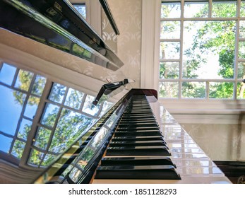 Nice upright piano with natural light reflection