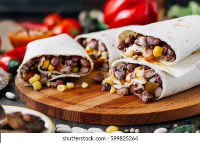 Nice Vegetarian Burrito Over Black Table On Wooden Board